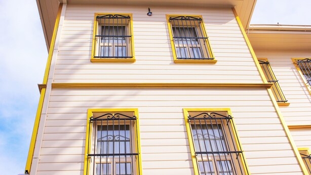 A building with three windows, each with yellow frames and black bars. - Ottoman's Pearl Hotel (Istanbul)