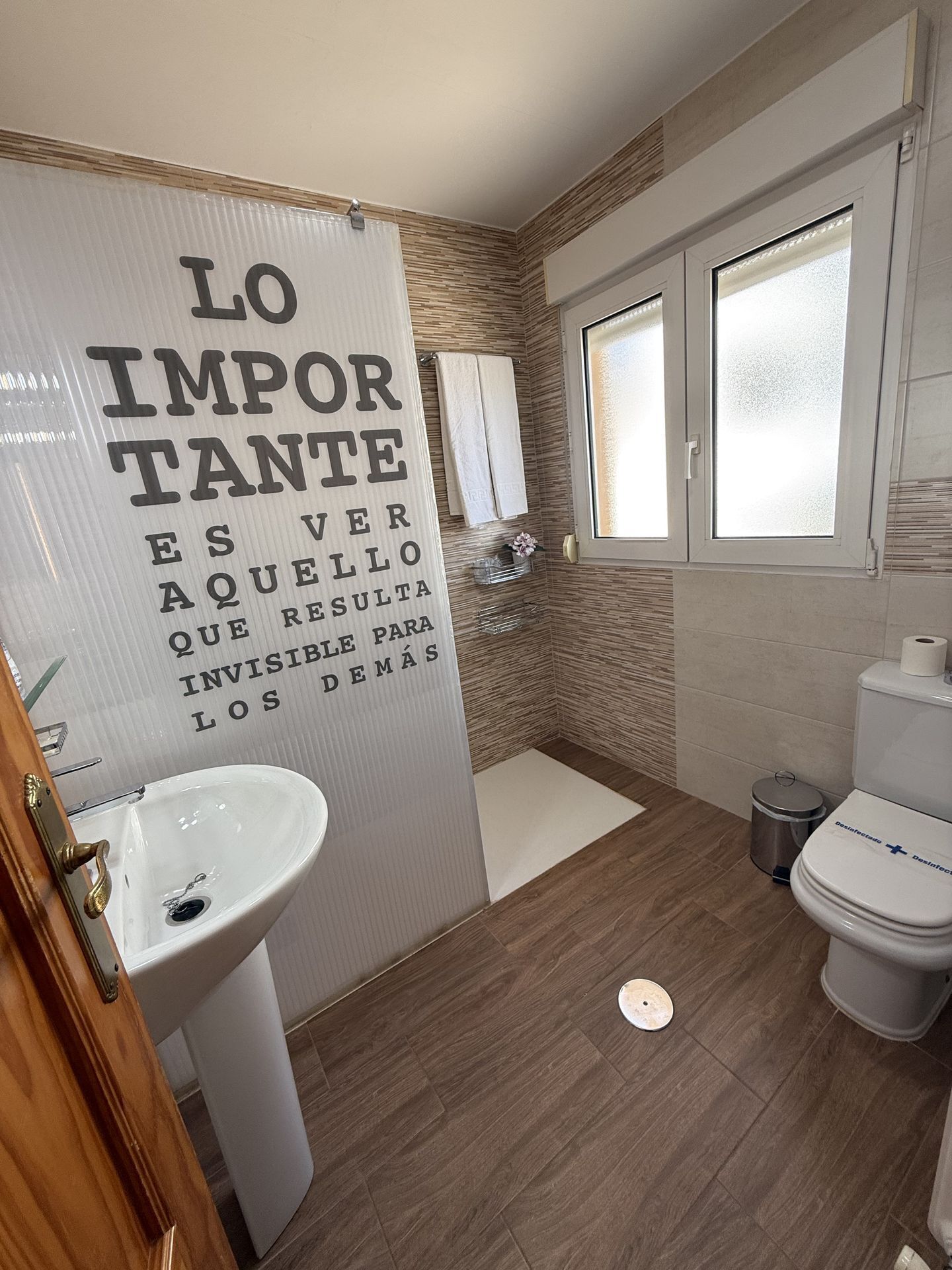 A modern bathroom with a sink, toilet, and shower.