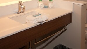 A bathroom with a white sink, a mirror, and a towel rack. - Holiday Inn Express & Suites Decatur by IHG (Decatur)