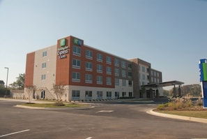 A Holiday Inn Express & Suites hotel with a modern architectural design, featuring a flat roof and a mix of brick and glass facade. - Holiday Inn Express & Suites Decatur by IHG (Decatur)