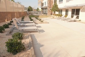 A poolside area with lounge chairs and a patio. - Holiday Inn Express & Suites Decatur by IHG (Decatur)