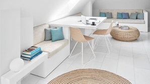 A modern, minimalist living space with a white sofa, a dining table, and a coffee table. - VISIONAPARTMENTS Zurich Militärstrasse (Zürich)