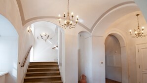 A grand hallway with a staircase, arched ceilings, and chandeliers. - Zámek Jeseník nad Odrou (Jesenik nad Odrou)