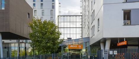 A modern building with a reception area labeled "Lodge In."