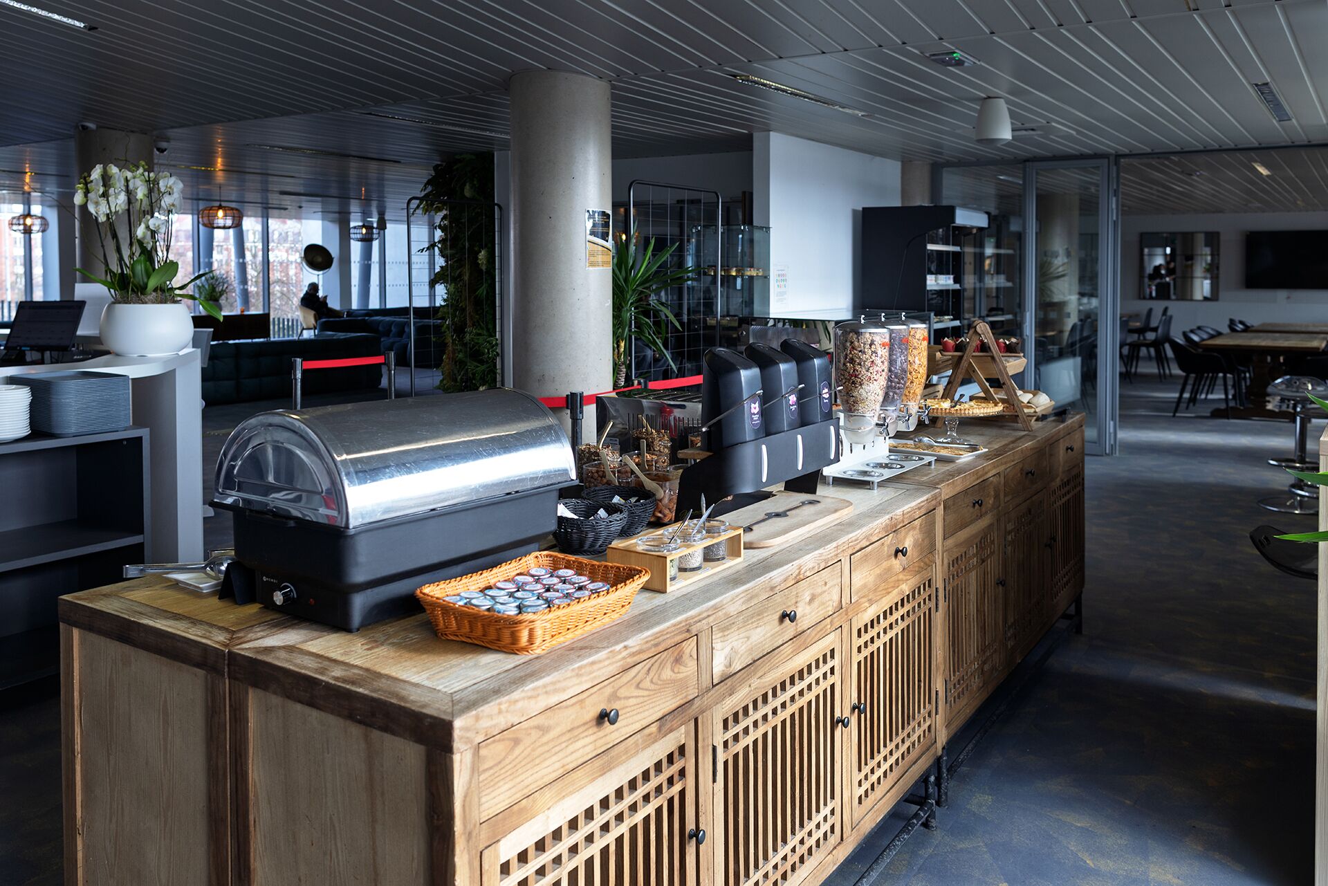 A buffet setup with a grill, beverage dispensers, and a variety of food items.