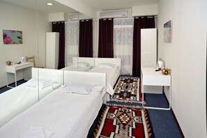 Economy Twin Room, 2 Twin Beds (Shared Bathroom) | Premium bedding, in-room safe, desk, laptop workspace