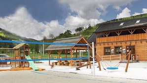 Une cabane en bois avec un télésiège à proximité, un espace de pique-nique couvert et une voiture garée non loin.