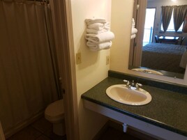 Standard Room, 1 King Bed, Non Smoking | Bathroom | Combined shower/tub, hair dryer, towels, soap