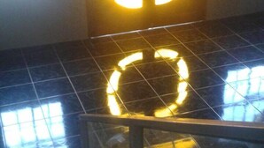 A staircase with a circular light fixture on the wall. - New Century Hostel (Granada)