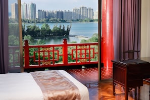 A hotel room with a large window overlooking a lake and high-rise buildings. - The Grand Hotel Kaohsiung (Kaohsiung)