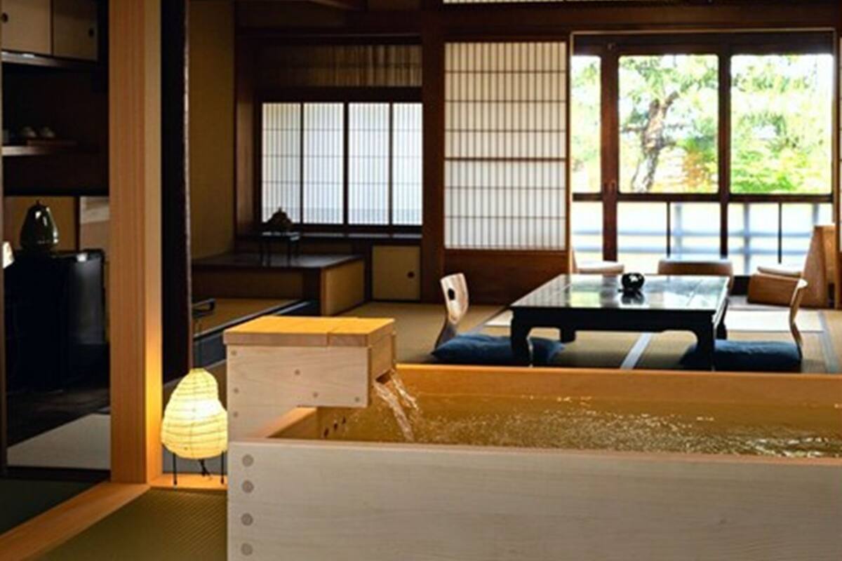 A traditional Japanese room with tatami flooring, a low table, and sliding shoji doors.