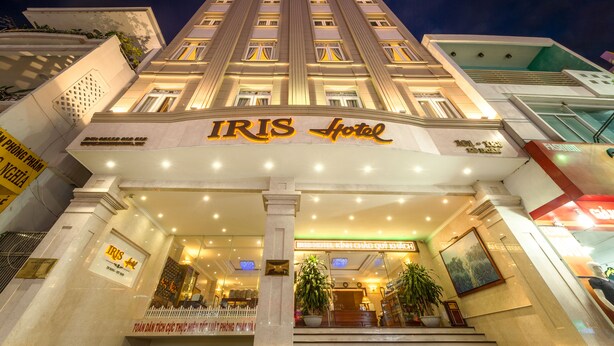 The exterior of IRIS Hotel with a grand entrance, multiple floors, and a well-lit facade. - Iris Hotel Danang (Da Nang)