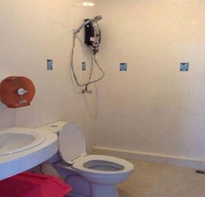 A bathroom with a toilet, a bidet, and a shower. - The Best Hostel (Koh Tao)