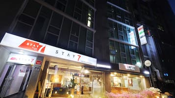 A hotel with a 'STAY7' sign, a coffee shop named 'TEMPTER', and a 'STAY' sign.