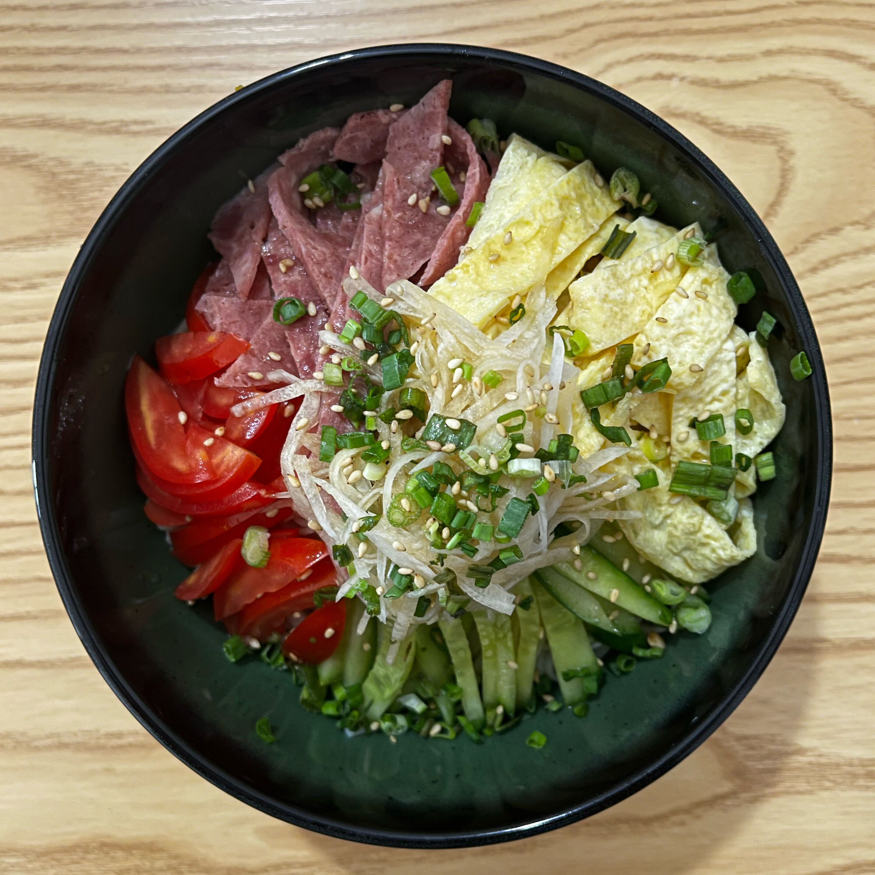 A bowl of food with various ingredients.