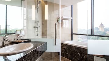 Combined shower/tub, designer toiletries, hair dryer, slippers