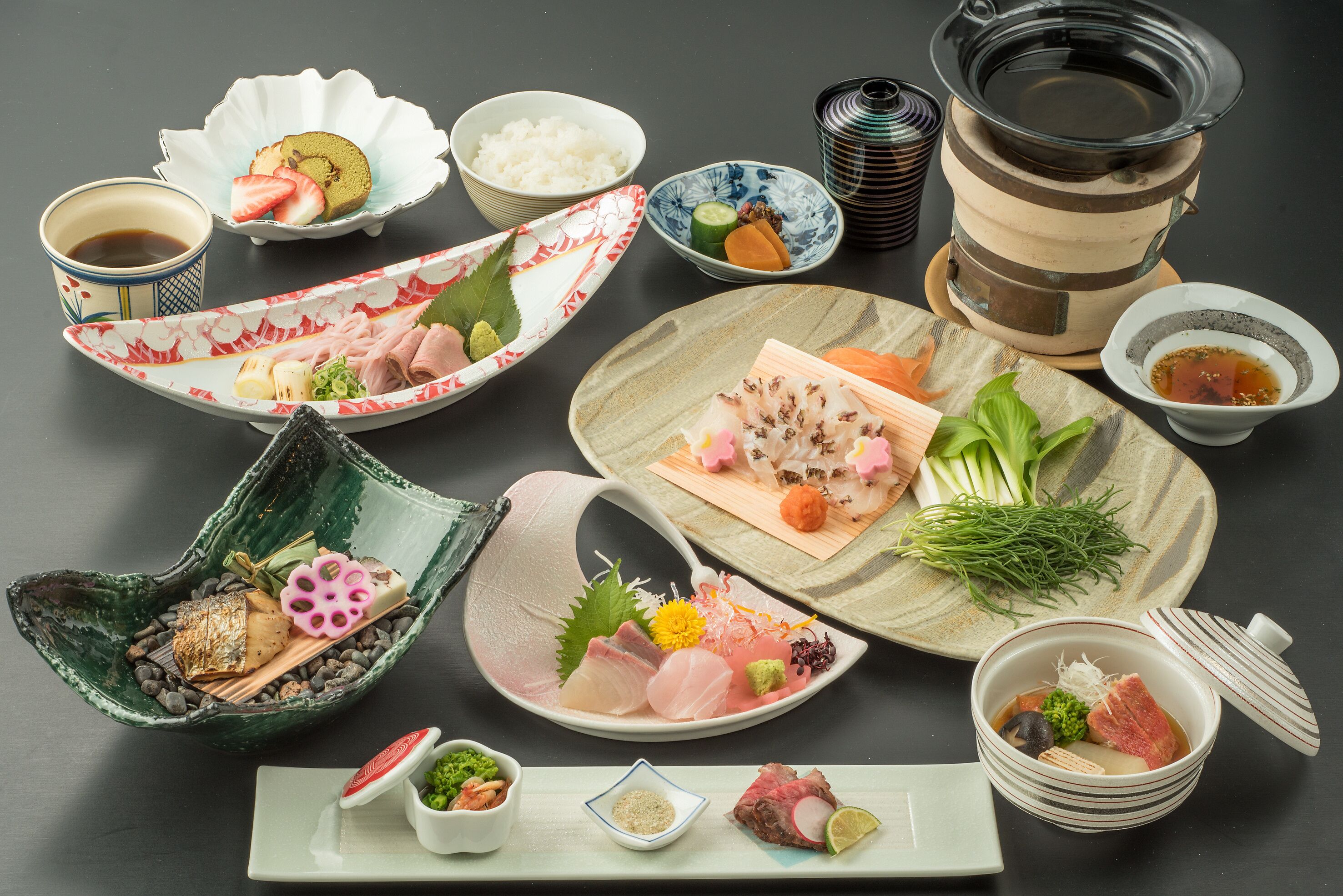 A variety of Japanese dishes and drinks arranged on a table.