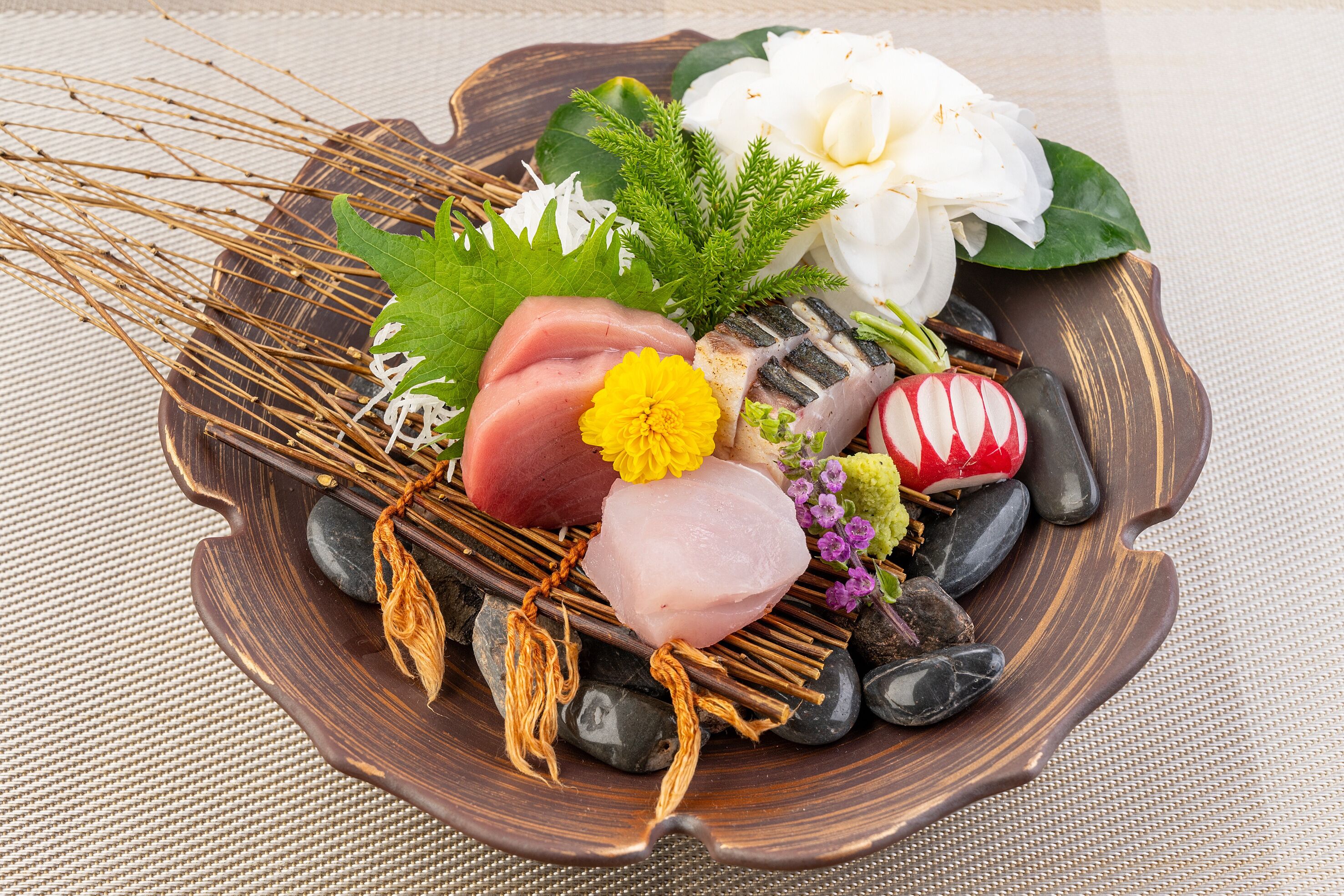 A wooden tray with various food items and decorations.