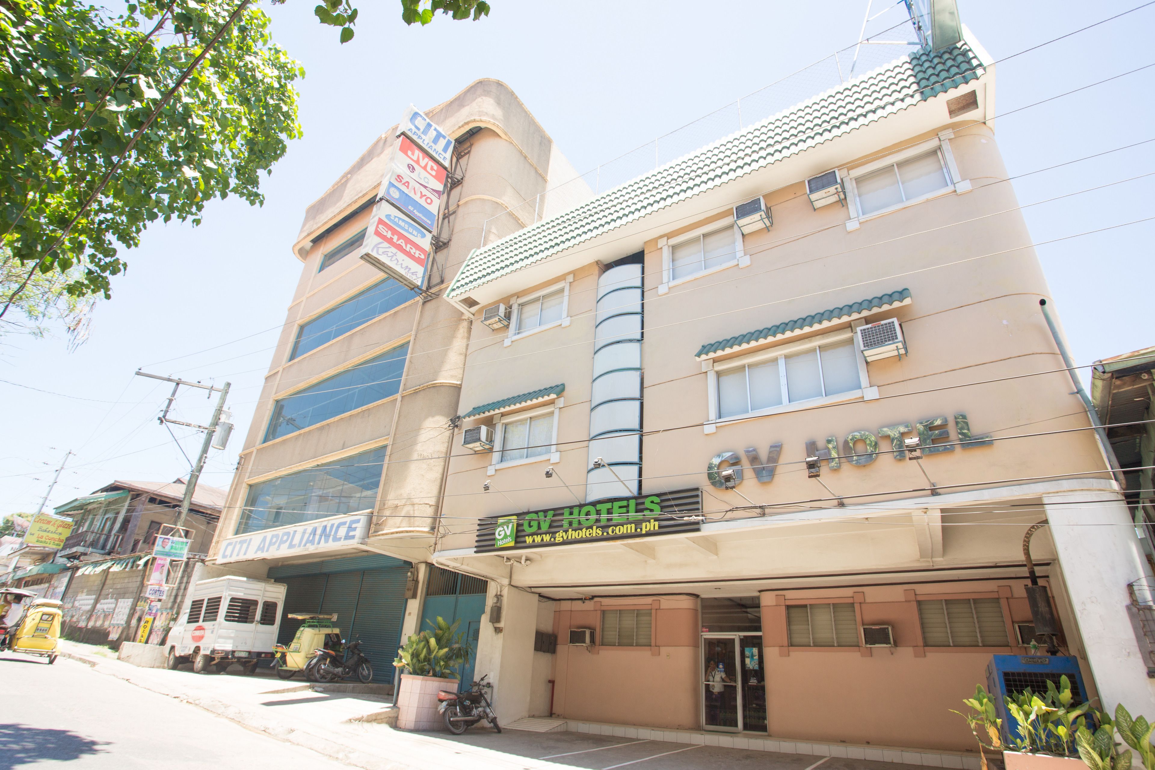 A hotel with a sign for 'GV Hotels' and 'Citi Appliance' on the facade.
