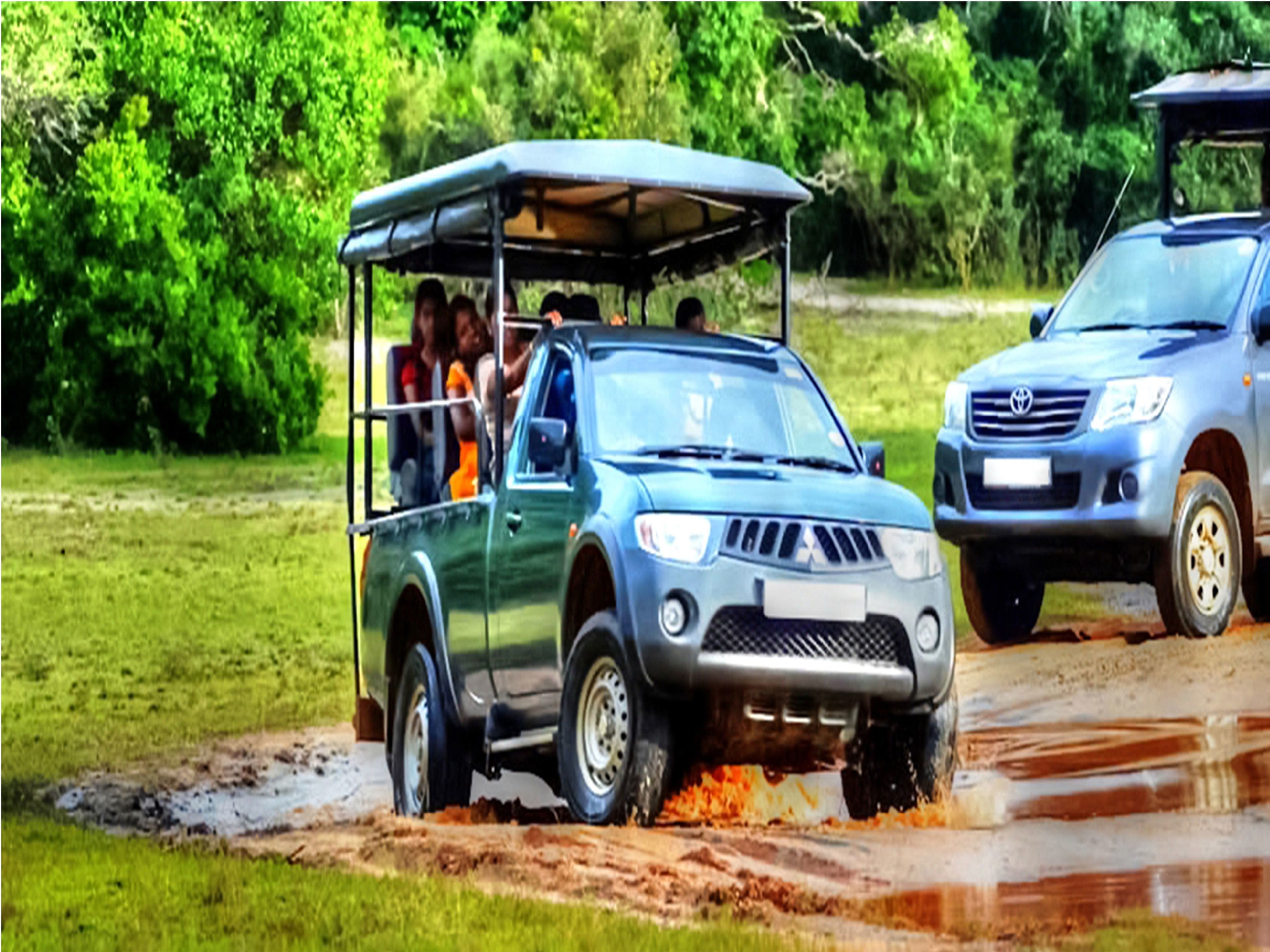 A vehicle with a roof and passengers, driving on a muddy path.