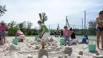 Guests can build sandcastles on the sandy surface.