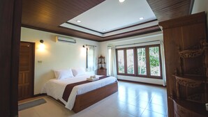 A spacious bedroom with a large bed, wooden ceiling, and a view of greenery outside. - Tak Andaman Resort & Hotel (Tak)