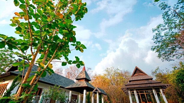 A traditional Japanese-style house with a thatched roof and a small pagoda-like structure. - Tak Andaman Resort & Hotel (Tak)