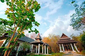 A traditional Japanese-style house with a thatched roof and a small pagoda-like structure. - Tak Andaman Resort & Hotel (Tak)