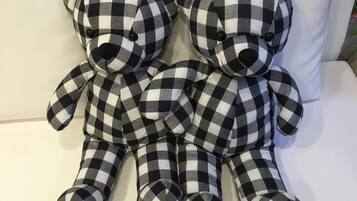 Two black and white checkered teddy bears sitting on a white surface.