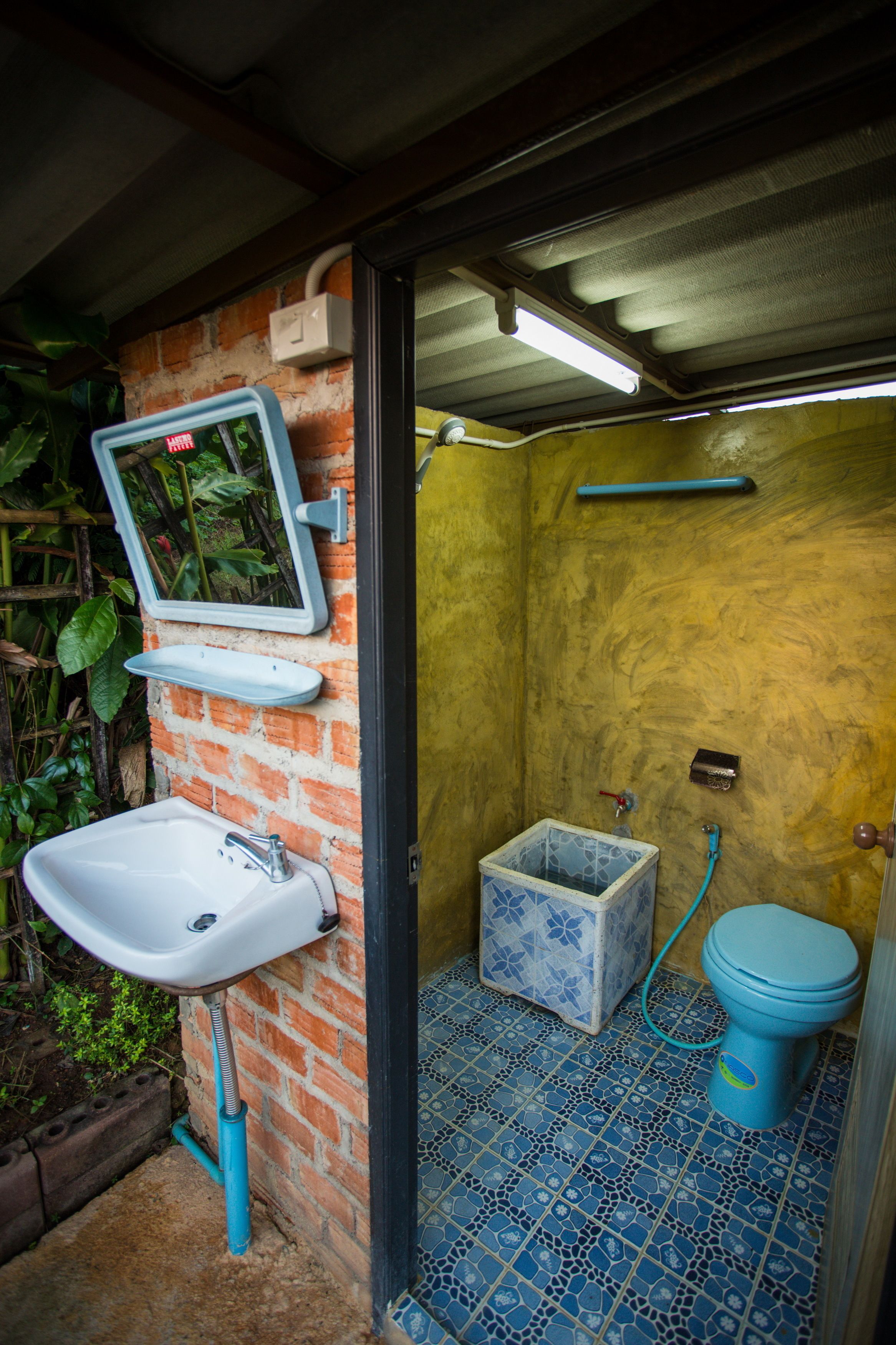 A small bathroom with a sink, toilet, and shower.