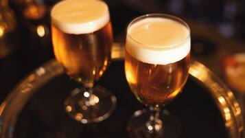 Two glasses of beer on a tray.