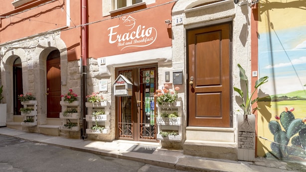 A building with a sign reading "Eraclio Bed and Breakfast" and a door with a window above it. - B&B Eraclio (Barletta)