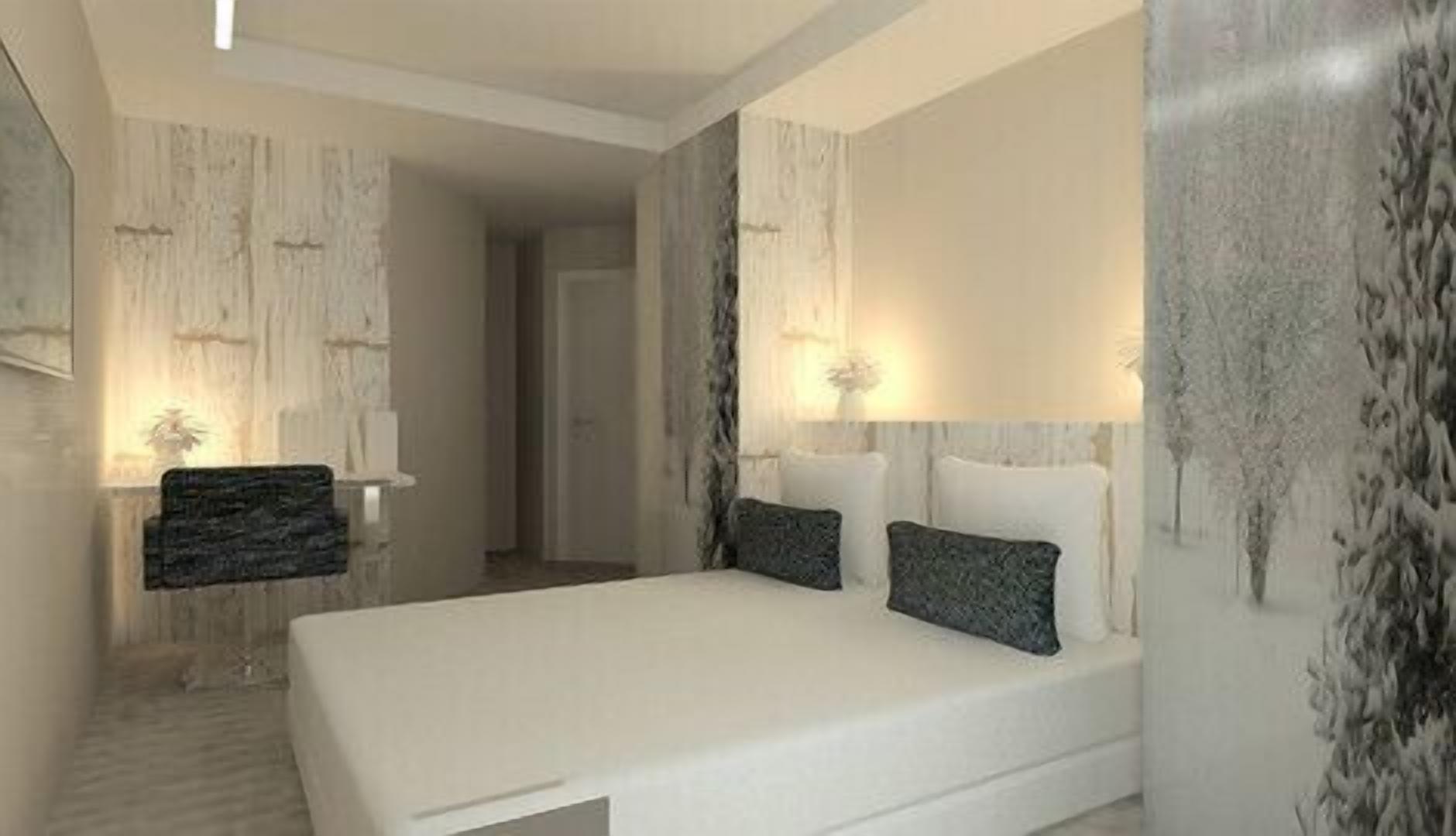 A modern bedroom with a large bed, two bedside tables, and a nightstand.