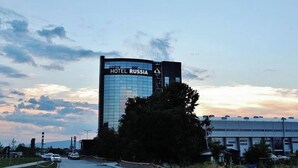 A modern hotel building with a glass facade and a sign reading 'HOTEL RUSSIA.' - Russia Hotel Skopje (Skopje)