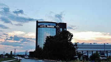 A modern hotel building with a glass facade and a sign reading 'HOTEL RUSSIA.'