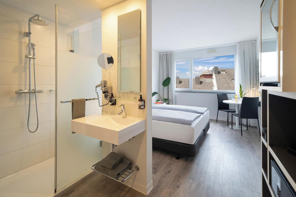 the innside premium room | bathroom | shower, rainfall showerhead, eco-friendly toiletries, hair dryer