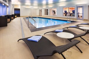 Una piscina techada, sillones reclinables de piscina