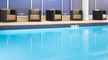 Relax by the pool with comfortable lounge chairs and tables.