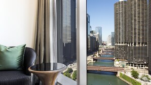 A modern room with a view of a river and high-rise buildings. - LondonHouse Chicago, Curio Collection by Hilton (Chicago)