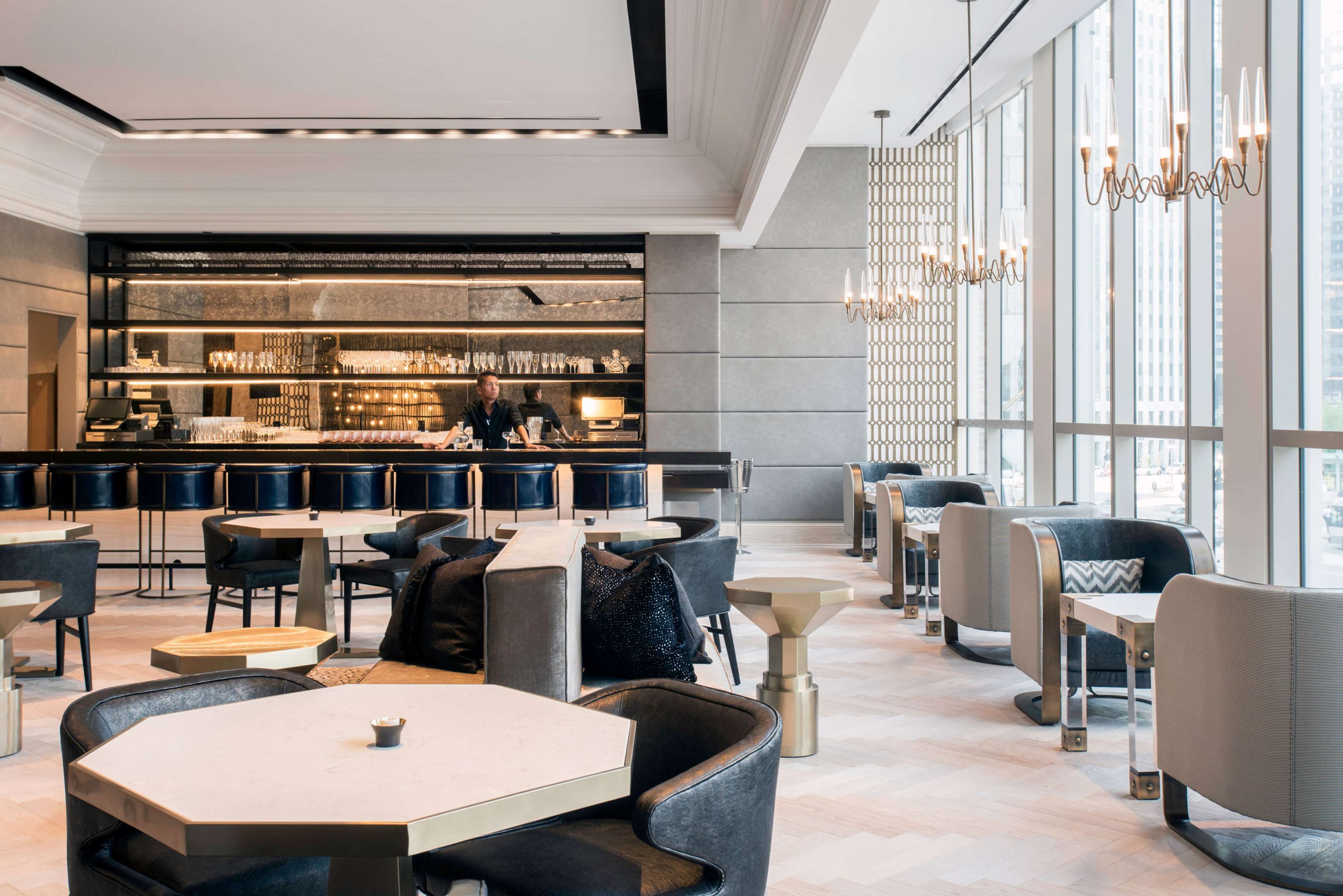 A modern bar area with seating and a bar counter.
