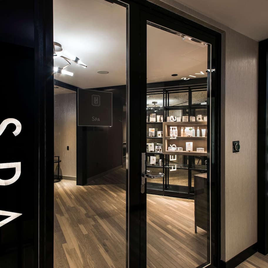 A hotel interior with a spa area, a minibar, and a well-lit corridor.
