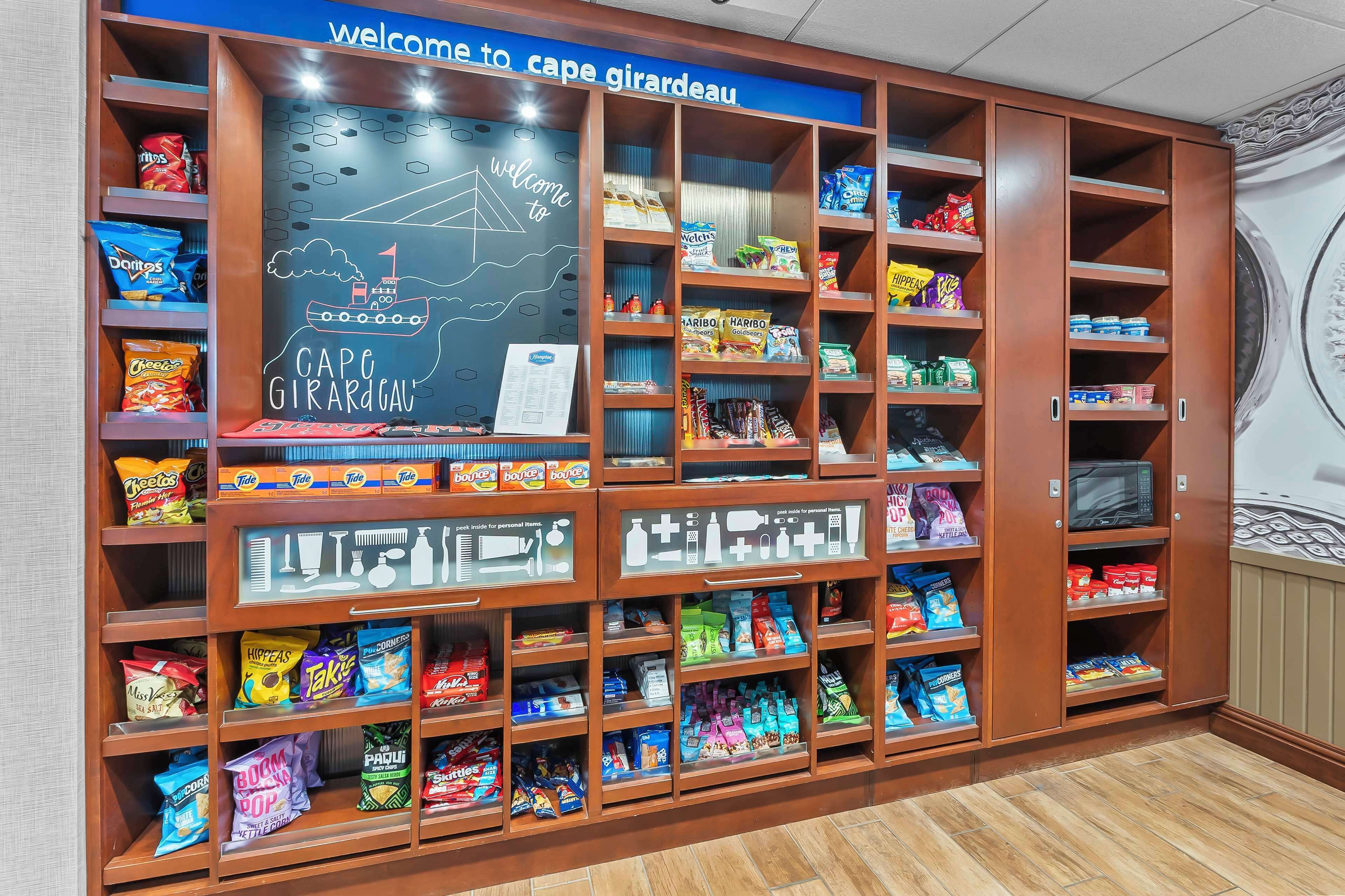 A snack display area with various packaged snacks and a chalkboard sign.