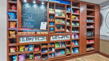 A snack display area with various packaged snacks and a chalkboard sign.