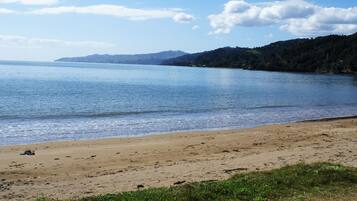On the beach, white sand, sun-loungers, beach towels