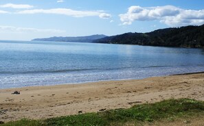 On the beach, white sand, sun loungers, beach towels
