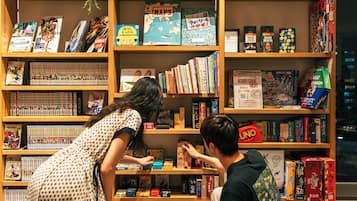 A bookstore with multiple shelves filled with books and games.