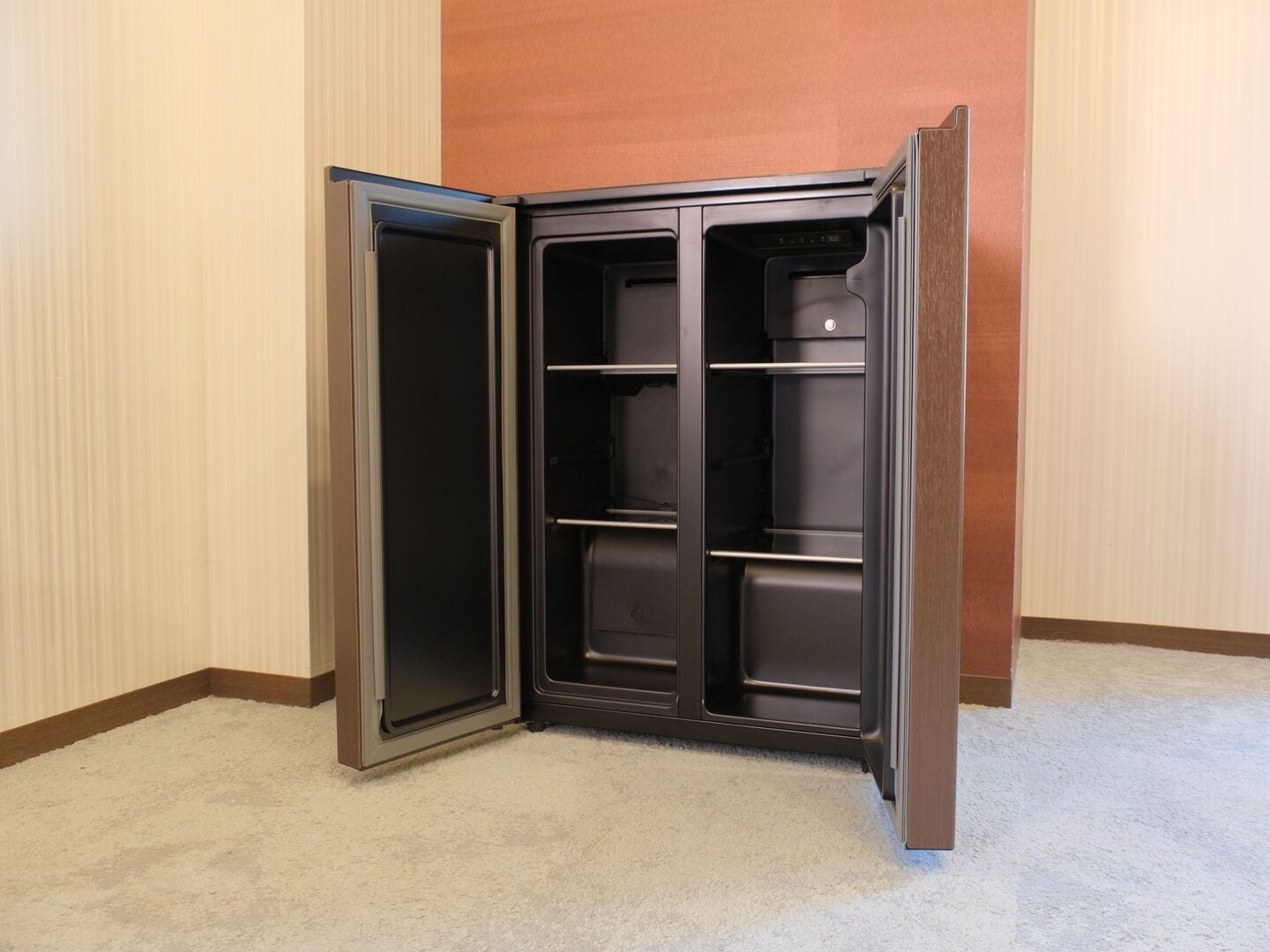 A corner closet with open doors, revealing shelves and a hanging rod.