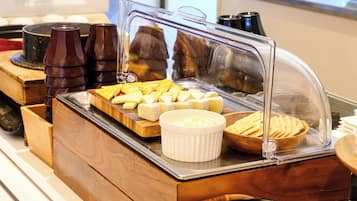 A breakfast buffet with various food items and condiments.