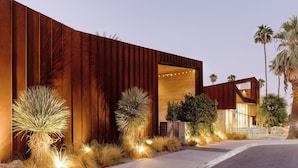 A modern building with a wooden facade, a visible entrance, and outdoor lighting. - ARRIVE Palm Springs - Adults Only (Palm Springs)
