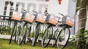 A row of bicycles with baskets, each labeled "Rice Village." - Rice Village Homestay (Da Nang)